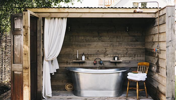 The simple yet elegant shape of this tin freestanding bath from Indigenous is ideal for creating an outdoor escape 