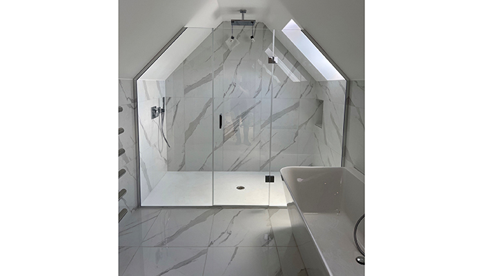 Installed for Malibu Bathrooms, The Shower Lab’s TSL View 05 M2M – Inline Panel + Door + Inline Panel recess enclosure is a prime example of how sloping ceilings can be seen as a benefit rather than a hindrance