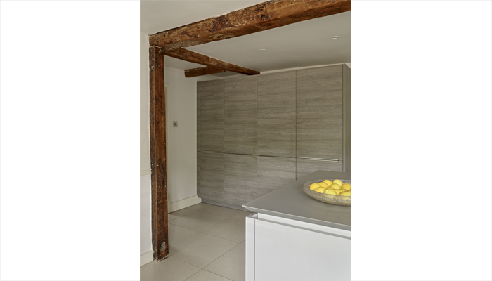 The units add warmth while letting original features such as wooden beams take centre stage