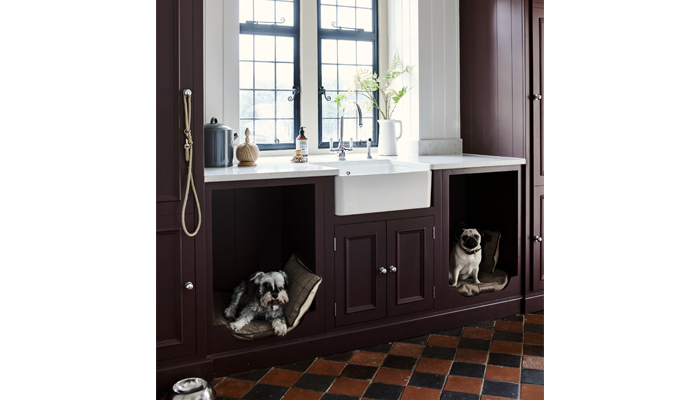 Neptune’s Chichester cabinets painted in Juniper are shown here with cubby holes for dog beds