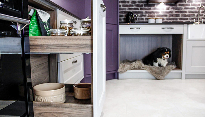Here Masterclass Kitchens’ Marlborough Highland Stone with Tuscan Walnut cabinetry (also seen in main picture) houses a dog bed beneath the sink, while MagnaSpace from the Signature Collection makes an ideal pet storage