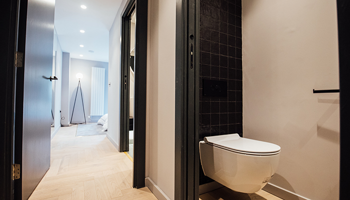 Space-saving pocket doors were used throughout and the addition of a cloakroom for guests meant the master en-suite could be kept private to residents