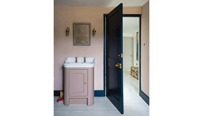 Here bathroom furniture and walls are both painted in Farrow & Ball's Pink Ground