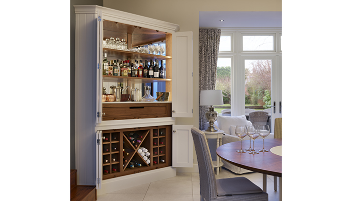 This magnificent corner drinks cabinet by Davonport has bi-fold doors for easy access and to create a visual centrepiece when the doors are folded back 