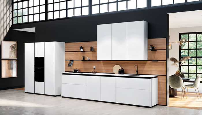 Rotpunkt’s Zerox HPL XT doors are shown in Daylight Grey and teamed with a wood-effect splashback and black shelving and appliances for striking contrast