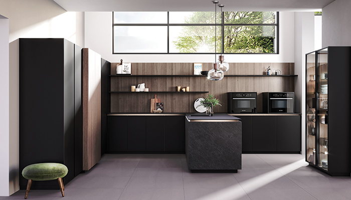 This scheme with Rotpunkt's new Ceramic Dark Grey doors features a winning combination of open shelving and tall units