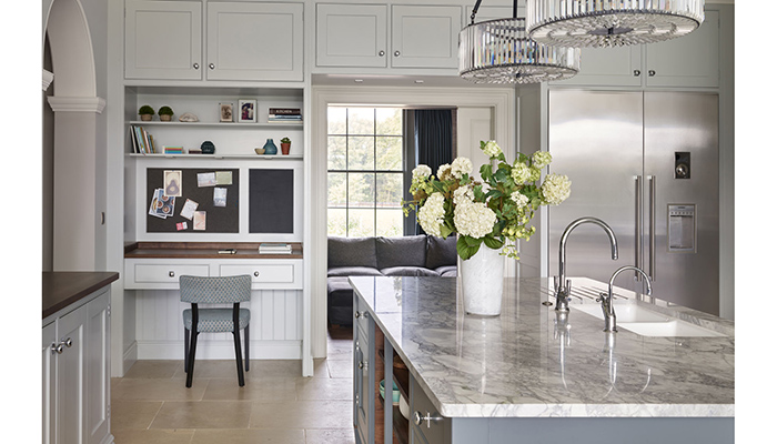 This home-working zone is seamlessly incorporated into Martin Moore’s New Classic cabinetry, and is balanced by a fridge-freezer located on the other side of the doorway for symmetry