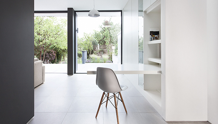 In this extension designed by architects AR Design Studio, The Myers Touch devised a pull-down desk area for home working that can be lifted up and closed to be completely hidden away. Photo by Martin Gardner