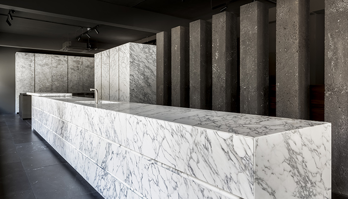 The sweeping 7.5m-long Gandhara island in Arabescato marble stretches almost the entire length of the showroom