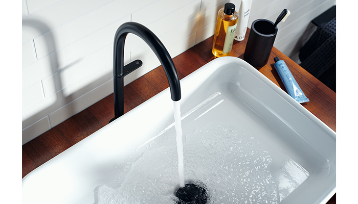 Axor One basin mixer with press down control lever used to start or stop the water, swivel clockwise to increase the temperature