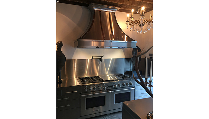 Chateau-style bespoke hood in brushed stainless steel with mirror polished detail