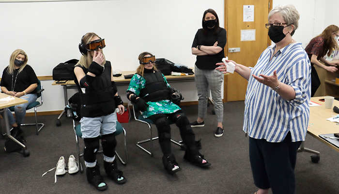 Lecturer Alison Messenger leads a session on accessibility, with first year students Lucy Heaney from Woodbridge Interiors, Suffolk, sponsored by Blanco, and Helen Gunby of Connells Kitchens Bedrooms & Bathrooms of Ipswich wearing empathy suits, designed to emulate what it is like to be challenged in movement, sight and hearing