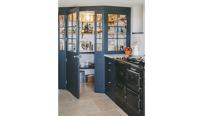 With its reclaimed oak door and matching glazing, this pantry is an impressive focal point in the kitchen. Created by Sustainable Kitchens for a client who loves to bake, it boasts surface space for food preparation as well as storage for dry ingredients