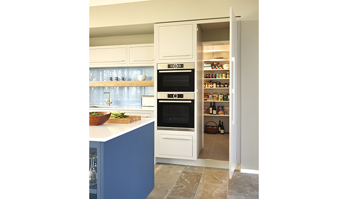 With the door closed, this pantry is cleverly disguised as a tall kitchen cabinet from Harvey Jones’ Linear collection