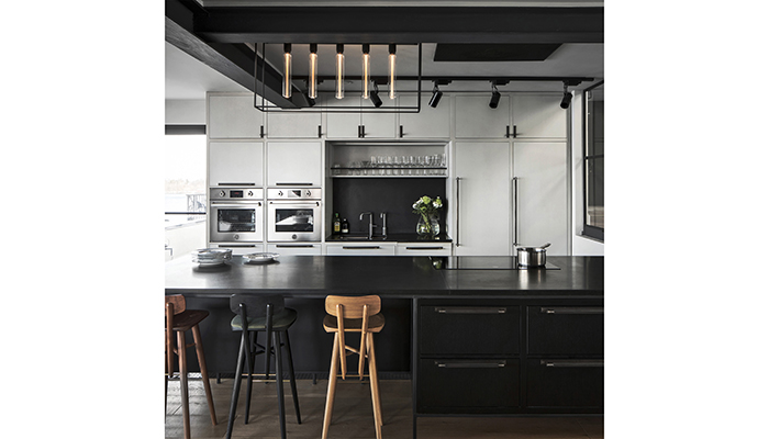 Kitchen scheme featuring Buster & Punch’s handles and caged ceiling light