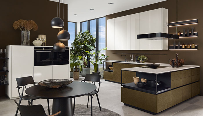 Combining both ultra matt and gloss finishes, this dramatic handleless design from Pronorm features Steelbrush Gold and Light Grey frontals from its X-Line+ and Proline 128 furniture ranges. Contrasting black steel frames give an industrial feel, while extra-tall wall units provide maximum storage