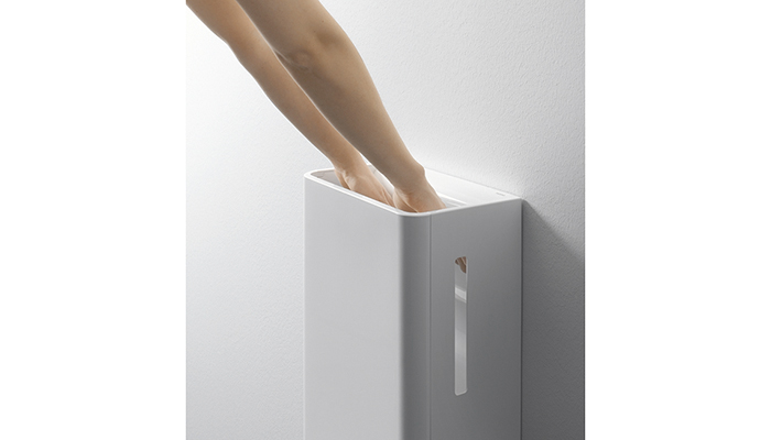 Toto's hand dryer with integrated drip tray enabling touch-free use of a commercial washroom