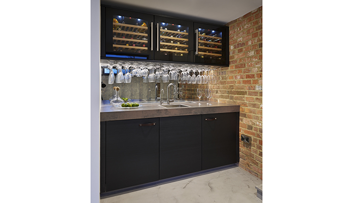 Designed by Snug Kitchens, this handy bar area and wine storage features Pronorm’s X-Line kitchen furniture range in a Black Pine melamine faced door which combines drama and practicality, enhanced by the deep worksurface and inset sink with mixer and mini filter tap
