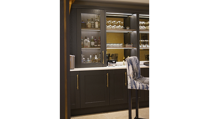 This custom home bar by Daval creates a feeling of cosy ambience with the use of bespoke cabinetry from the Farnley range. The clients were delighted with the addition of a Kaelo UK cooler integrated in the worktop to ensure that the next bottle is always chilled and ready to pop