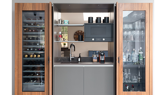 Designed by Gavin Alexander and Darren Taylor, this bespoke, built-in unit offers a pleasing symmetry in the equally-sized glass doors to the Gaggenau wine climate cabinet and the gin and spirit storage area. Both feature UV protection to stop light affecting the contents within