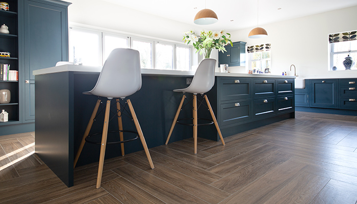 Old English wood look porcelain tiles are shown laid in a herringbone pattern