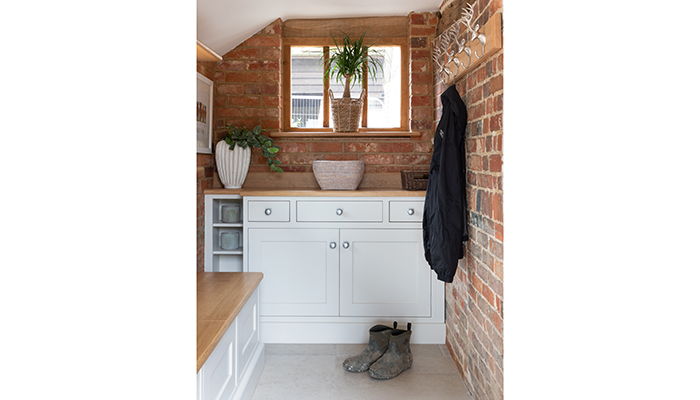 This bijou boot room by Searle & Taylor features a rack to hang wet coats after dog walking, plus a lift-up bench seat for shoes and boots. The bespoke cabinetry features a large cupboard to accommodate pet paraphernalia, with drawers above for storing car keys and other essential items