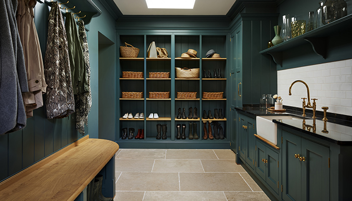 This striking boot room was designed to maintain peace and order in a busy household of five. The entire back wall of the room has been re-fitted with open shelving, while additional boots and wellies are stored underneath bench seating. Bespoke cabinetry from Martin Moore’s New Classic Collection is hand painted in Martin Moore’s ‘Viridian’