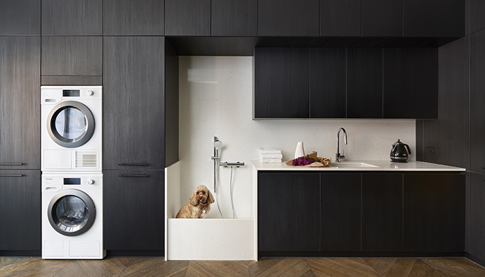 With a dedicated dog shower and plenty of storage, this stunning utility area from Design Space London is the ideal solution for clients who are faced with muddy paws on a daily basis. The cabinets are in black wood laminate with practical Carrara marble-effect composite stone on the worksurface, splashback and shower