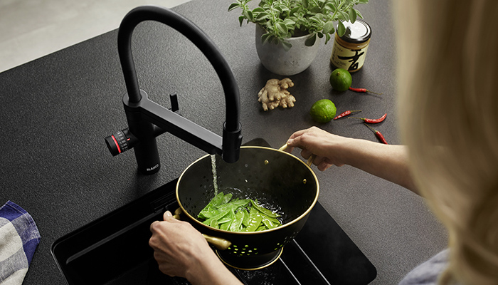Evol-S Pro 4-in-1 mixer in matt black, which delivers standard hot and cold water with two spray options via the mixer lever on the right, with rotary control and measuring dial, left, for selecting cold filtered or true-boiling filtered water in exact amounts, if required