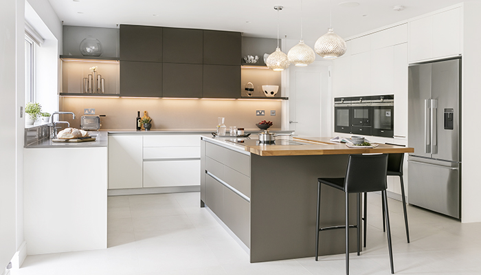This kitchen featuring Scavolini’s bestselling LiberaMente range contrasts base and larder units in Pure White with wall cabinets, shelves and island unit in Earth Grey. Bridging the gap between the white and dark grey shades, the raised wooden breakfast bar has a walnut finish to bring a warm, natural look and feel to the space