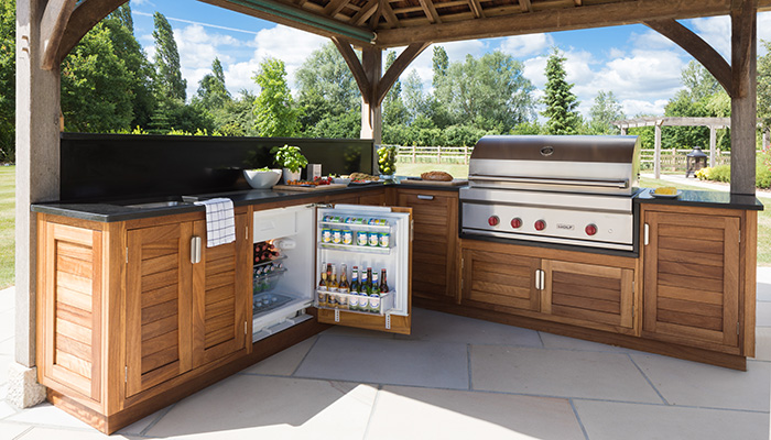 This outdoor kitchen by Humphrey Munson comprises Markham doors made from Iroko with marine plywood carcasses and finished with stainless steel hardware. The star of the kitchen is the large Wolf outdoor grill