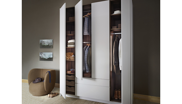 Ideal for clients looking to embrace a neutral colour palette in the bedroom, Roundhouse’s Metro wardrobe in Cashmere grey matt lacquer has Integra handles, a walnut interior, and dovetail drawers