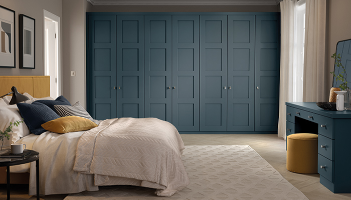 Tapping into the trend for Shaker-style furniture throughout the home, the wall-to-wall fitted wardrobes seen here in the dramatic Lithadora colour are from Neville Johnson’s Wentworth range