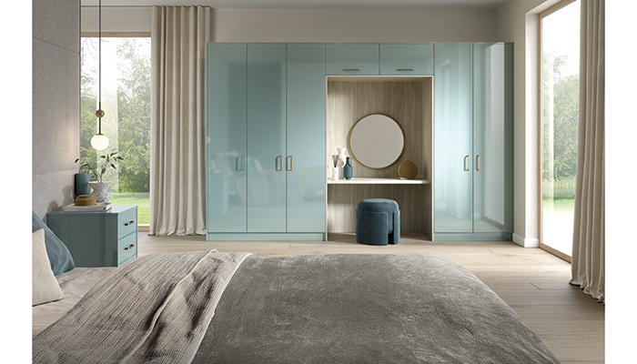 This contemporary bedroom features full-height wardrobes, which incorporate a practical dressing table, and matching bedside units in UltraGloss Metallic Blue from BA’s Zurfiz range