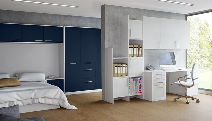 Creating a seamless divide between bedroom and home office, Crown Imperial’s Zeluso floor-to-ceiling wardrobes and over-bed storage, finished in Midnight Blue, is complemented by crisp white Zeluso furniture from the Crown Lifespace collection