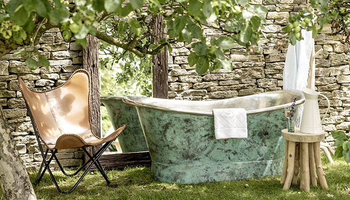 This freestanding Oxidised Copper Bath Tub from Indigenous is handmade in the bateau style with the stunning mottled turquoise patina layered over highly polished tin. The finish is created by applying salt to the metal and heating the surface until the distinct colour and texture is achieved