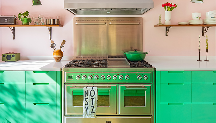 Sustainable Kitchens’ Granada Green cabinetry features its J-Handle Scoop design to keep the focus on the other bold elements in the space such as the vivid colours and reclaimed accessories