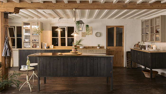 Utilising sustainable British timbers, the Sebastian Cox kitchen by DeVol showcases circular cutouts in the cabinetry, which are lined with a hint of opulent copper