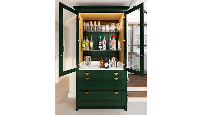 The new Thistleton drinks pantry in Thicket with beaded back panels, mirrored splash back behind the top shelf, a counter in Minerva solid surface and Dark Brushed Brass Ribbed Elipse handles