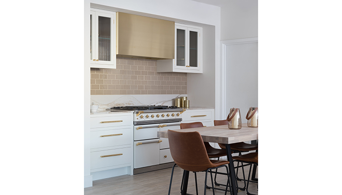 The Industrial display in the flagship Mill Hill showroom features a bespoke Westin extractor above a classic Lacanche range cooker