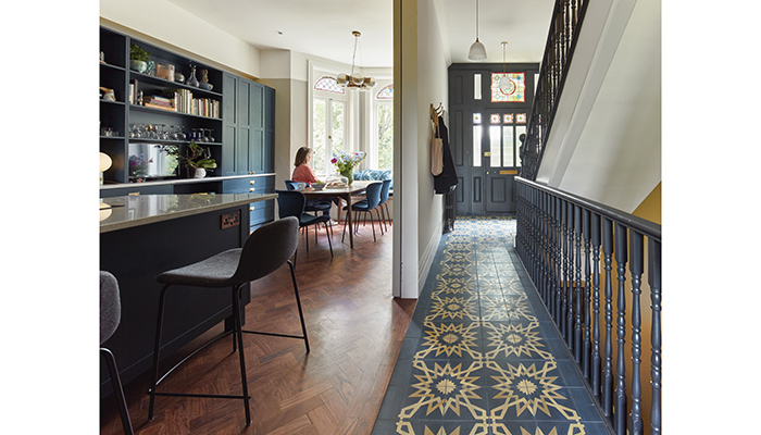 This bespoke ‘front of house’ kitchen and dining area designed by Vawdrey House has subtle Shaker styling and is painted a rich blue to complement the deep tone of the carefully restored hardwood parquet flooring