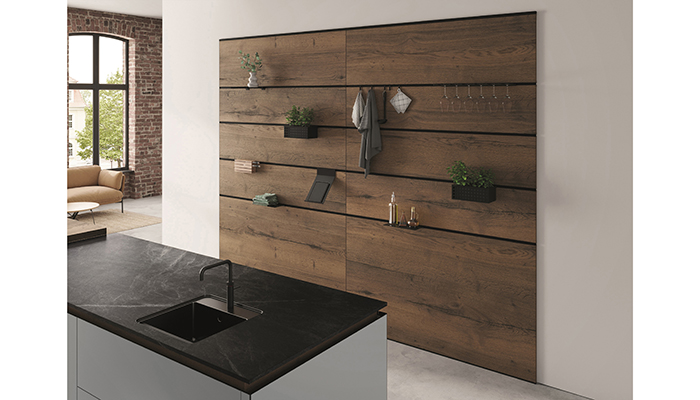 Seen here in the new Dark Split Oak, storage options for Rotpunkt’s wall-panel system includes glassware holders, industrial hooks, slimline storage caddies, metal shelves, a tablet holder, and a side-facing wooden knife block. Each accessory is designed to clip straight on to the panels for endless customisation, even the shelves can slide left and right. Designers can apply a single full-height panel or personalised arrangement made-up of multiple panels to better suit the space and individual needs