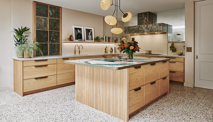 The Camden kitchen by Ledbury Studio features on-trend fluted oak detailing at either end of the island, and the Ambra quartz splashback has been fluted to match