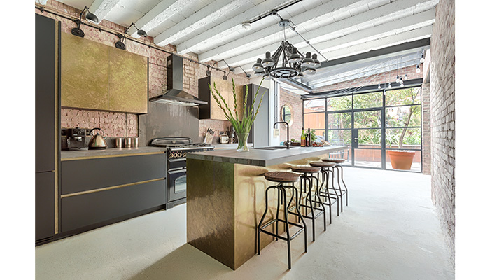 Taking metallics to a whole new level, Sola Kitchens’ Mountview project features antique brass clad doors on the kitchen cabinets alongside more down to earth materials like black ultra-matt laminate doors, alongside finishing touches such as brass inlays for the integrated handles, and industrial-style Dekton worktops