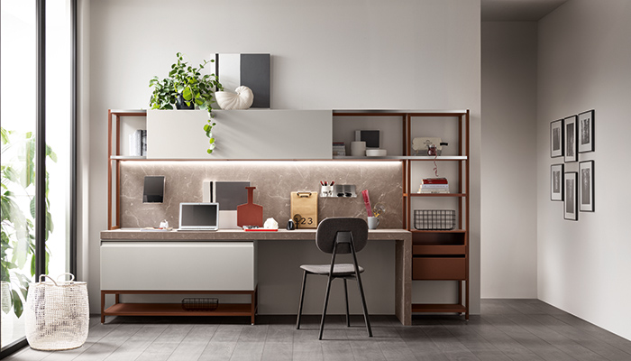 Created in collaboration with designer Vittore Niolu, Scavolini’s Formalia furniture has been designed for use in kitchens, bathrooms, living and offices spaces. The home office solution seen here is built around a PET base unit and sliding door in Rain and complemented by a Status wall system in Rust. The desk is made from Botticino-coloured Unicolour laminate