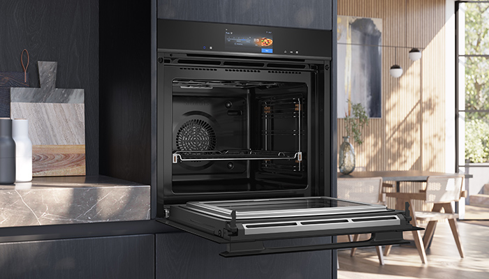 The new Siemens iQ700 ovens have an elegant dark glass front with a barely visible, matching glass handle, and a sleek touch-control panel. They feature sensor technology and AI to enable users to adapt baking and roasting results to suit their own personal preferences. Inside the cavity is a camera that monitors the browning process of a dish – data supplied by the camera allows the AI to 'know' when a dish is done, and then notify the user by sending a push notification to a smartphone or tablet via the Home Connect app