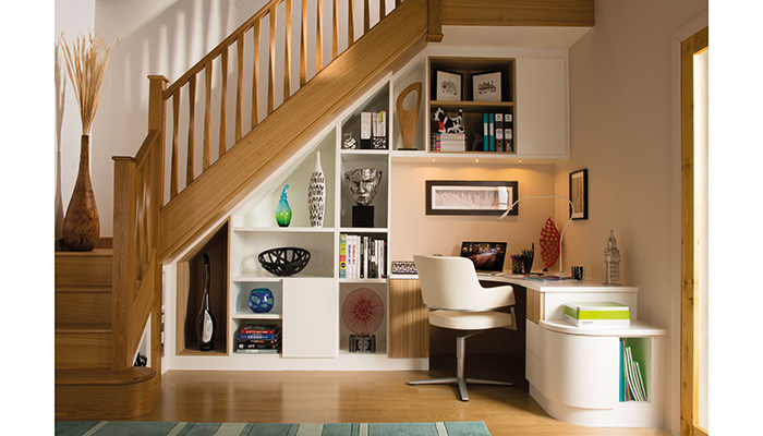 Neville Johnson has created a welcoming study zone in this large under stairs space by using a mix of painted and wood finish surfaces. The curved desk unit and drawers have been designed to fit the highest space under the stairs  allowing for plenty of head room