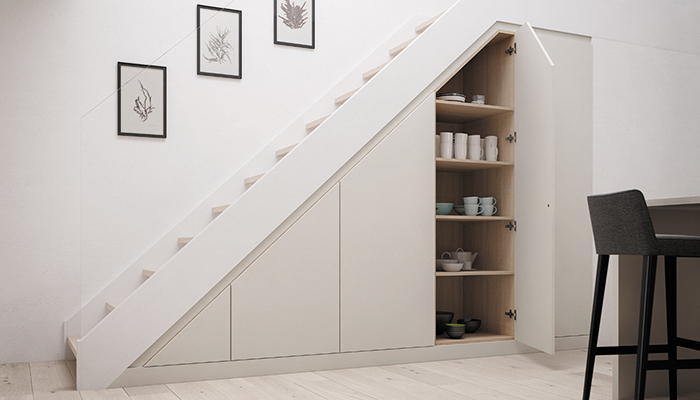 A minimalist design from the Finsbury Kitchen Collection by Daval, made to measure with a UV lacquered finish, is ideal for this open-plan layout. This under stair storage system is seen here with a Blonde Wood interior and Mayfair Dove Grey finish