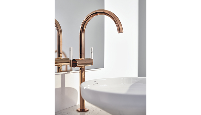 The Grohe Atrio Private Collection Basin Mixer in a Warm Sunset finish has stick levers in Caesarstone white Attica that oozes elegance. The monobloc mixer has an extra-high C-spout with a hard-wearing StarLight finish using physical vapour deposition (PVD) for highest scratch-resistance