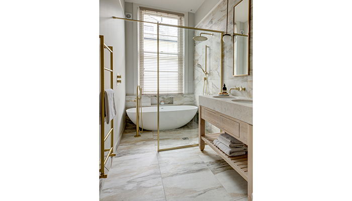 Using matching Antique Marble Macchia Vecchia Porcelain large-format wall and floor tiles from Lapicida has created a feeling of hotel luxury in this smaller scheme